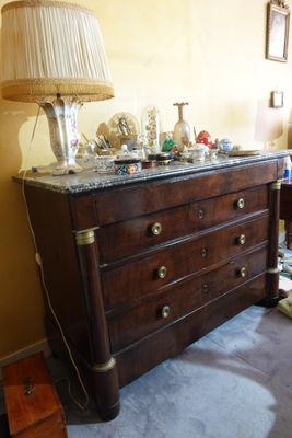 a dresser with a lamp on top of it in a room