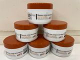 six jars of body butter sitting on top of a white counter