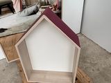 a small dog house on a pallet in the middle of a room