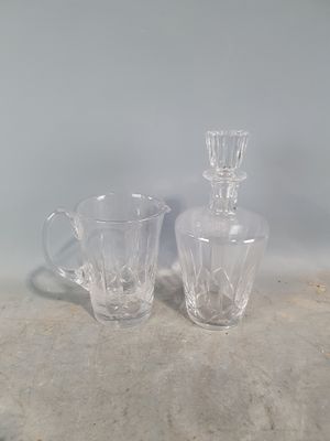 two glass vases sitting next to each other on a table