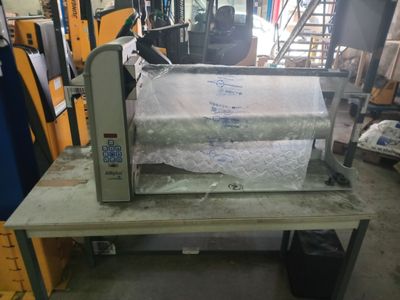 a machine that is sitting on a table in a warehouse