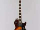 an electric guitar on a stand against a white background