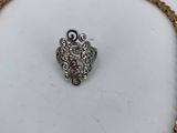 a gold and silver necklace with a heart shaped clasp