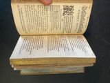 a hand that is holding an open book on top of it