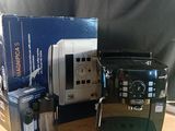 a coffee machine sitting on a table next to a box of coffee