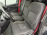 the interior of a car with the door open and the driver ' s seat down