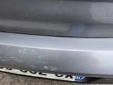 a close up of a car ' s bumper with a number plate on it