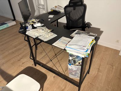 a desk with a chair and a computer on it