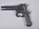 a small gun that is on a white surface