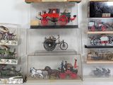 many different types of toy vehicles on the shelves