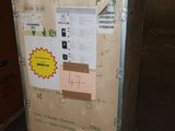a refrigerator that is sitting in the middle of a room