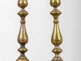 pair of antique brass candlesticks on a wooden table