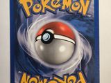 a close up of a pokemon card on a white surface