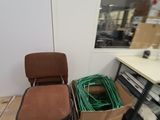 two chairs and a table in a room with a lot of boxes