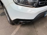 the front end of a white pick up truck parked in a parking lot