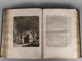 an open book with a picture of a group of people in a room