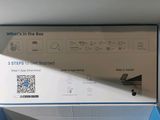 a box with a picture of a toilet and a toilet paper dispenser in it