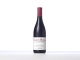 a bottle of red wine sitting on top of a table