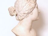 a marble bust of a woman on a marble pedestal