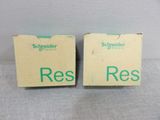 two boxes with the words ress on them sitting on a table