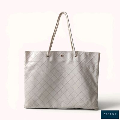a white tote bag sitting on top of a white table