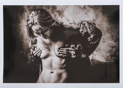 black and white photograph of a naked woman with hands on her chest