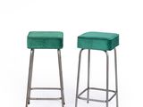 two green stools sitting next to each other on a white surface