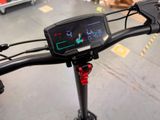 a close up of a bike handlebar with a clock on it