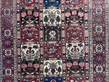 a red and blue rug with many different designs on it