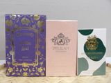 three boxes of perfume sitting on top of a table next to each other