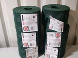 two rolls of green fabric sitting on a table