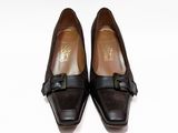 pair of women ' s black shoes with a bow on the toe