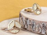 two rings that are sitting on top of a piece of wood
