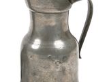 a silver pitcher with a handle on a white background