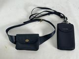 black leather cell phone case and wallet on a white table