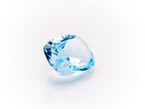 a close up of a blue diamond on a white surface