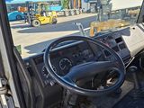 a view of the inside of a truck from the driver ' s seat