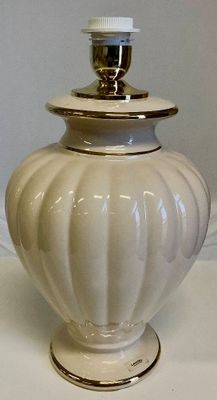 a white vase with a lid sitting on a table
