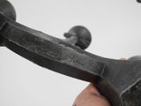 a hand that is holding a metal object in it ' s right hand