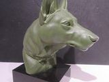 sculpture of a dog ' s head on a black base
