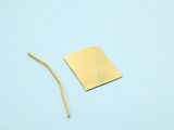 a piece of paper and a piece of wire on a blue surface