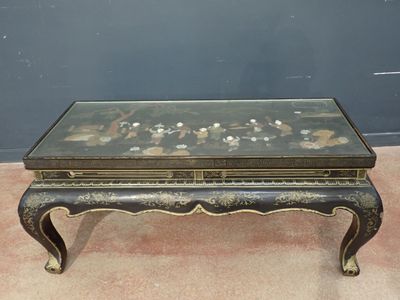 an image of a coffee table with a glass top on a carpeted floor