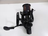 a close up of a fishing reel on a white surface