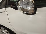 a small white car parked in a showroom