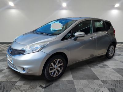 a silver car is parked in a room with a checkered floor