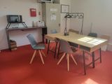 a table and chairs in a room with a red floor