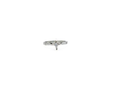 a ring with a diamond in it on a white surface