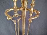 a gold statue of a man and a woman holding two canes