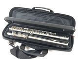 a flute in a black case on a white background