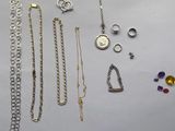 many different types of necklaces and bracelets laid out on a table